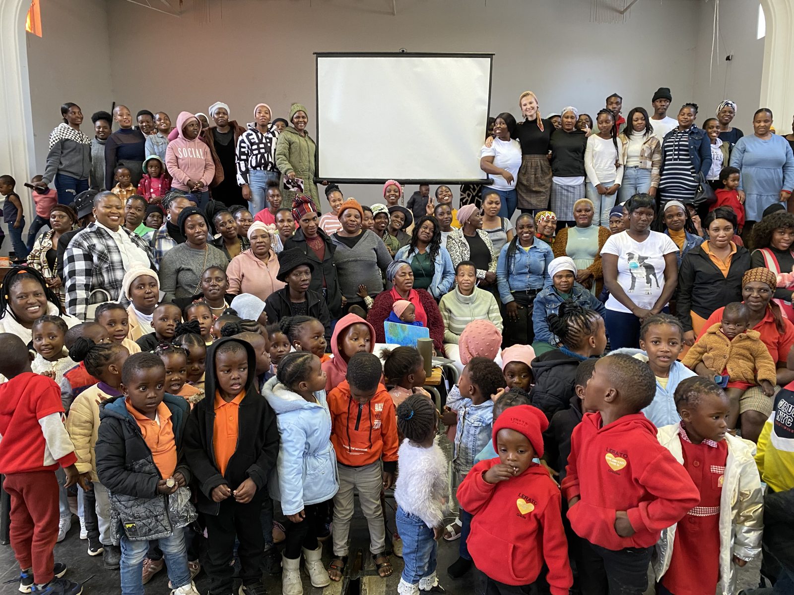 A large hall filled with educators, parents, and young children at a ReTsoga conference in Limpopo